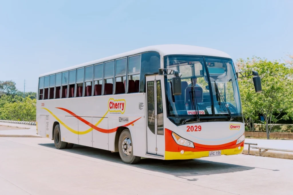 A Cherry Bus coach parked and waiting to load a group.